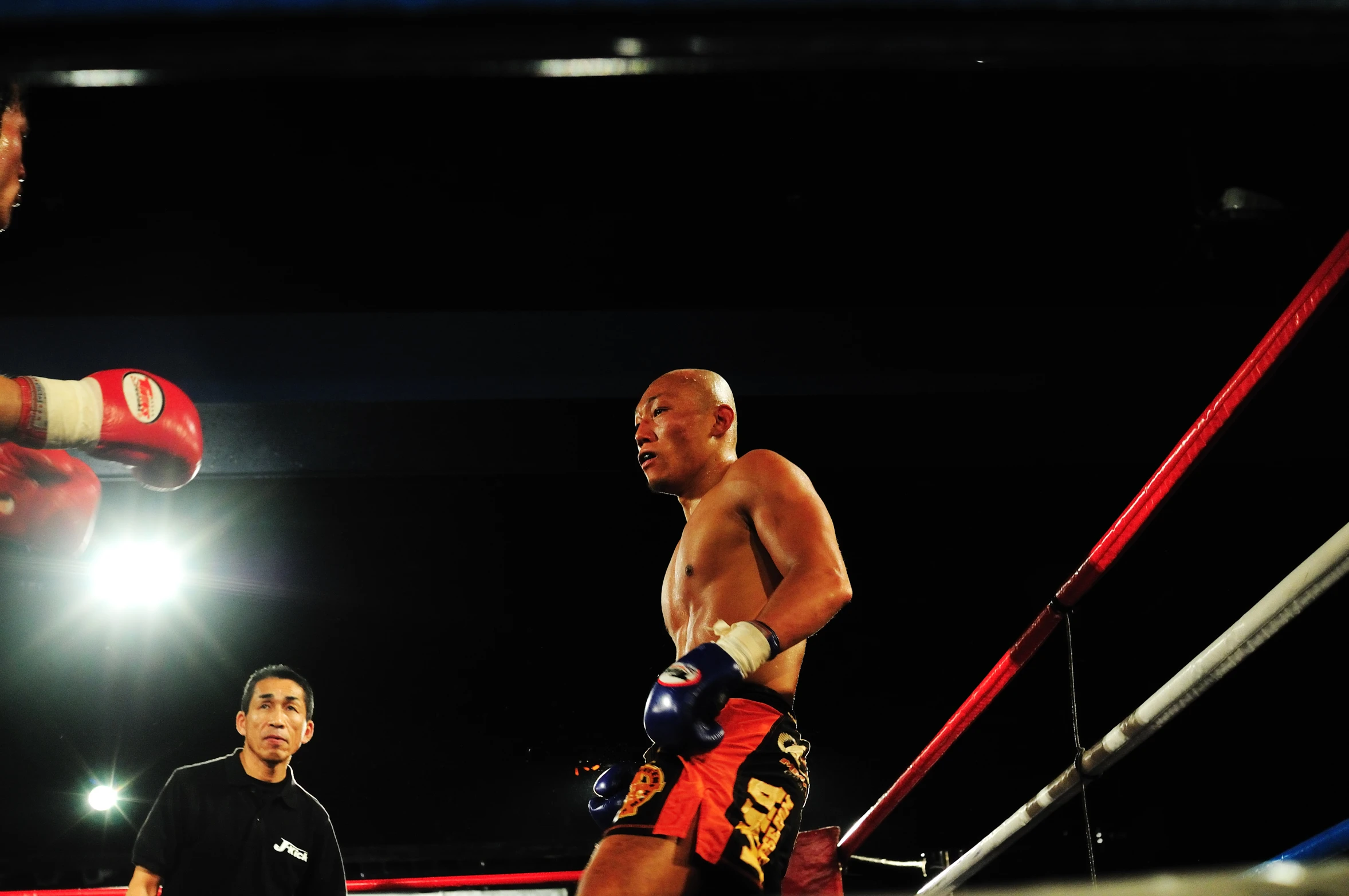 two men wearing boxing gloves standing next to each other