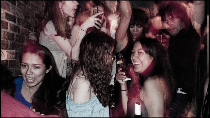 group of people in a club party dancing and having drinks