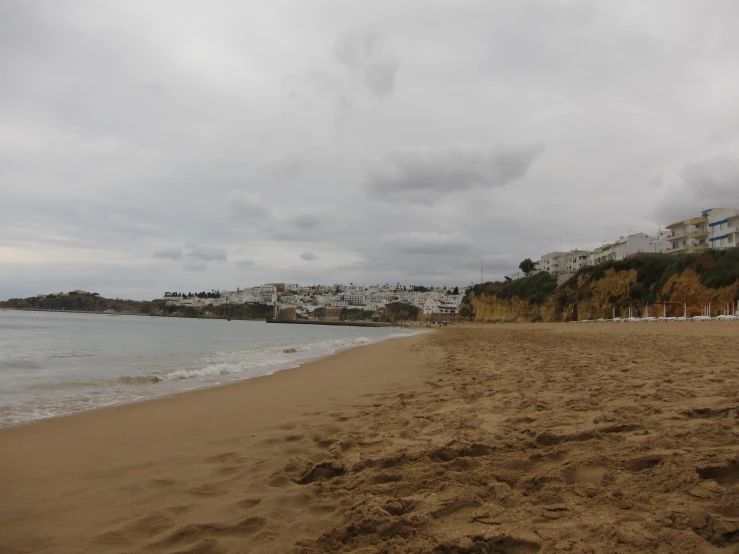 a sandy beach that is next to the ocean