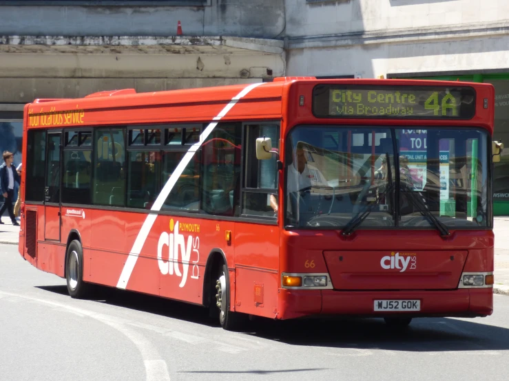 a city bus drives down the street