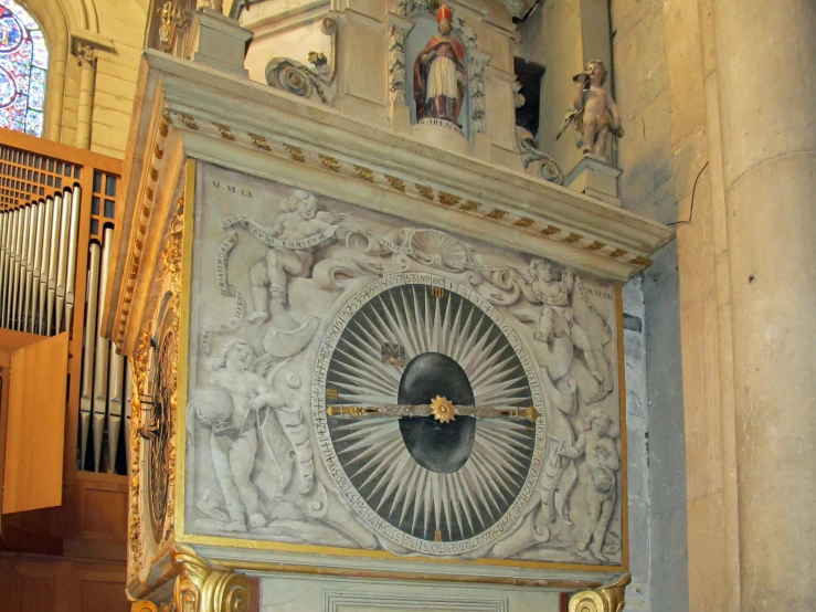 a room with a large statue and some decorations on the wall