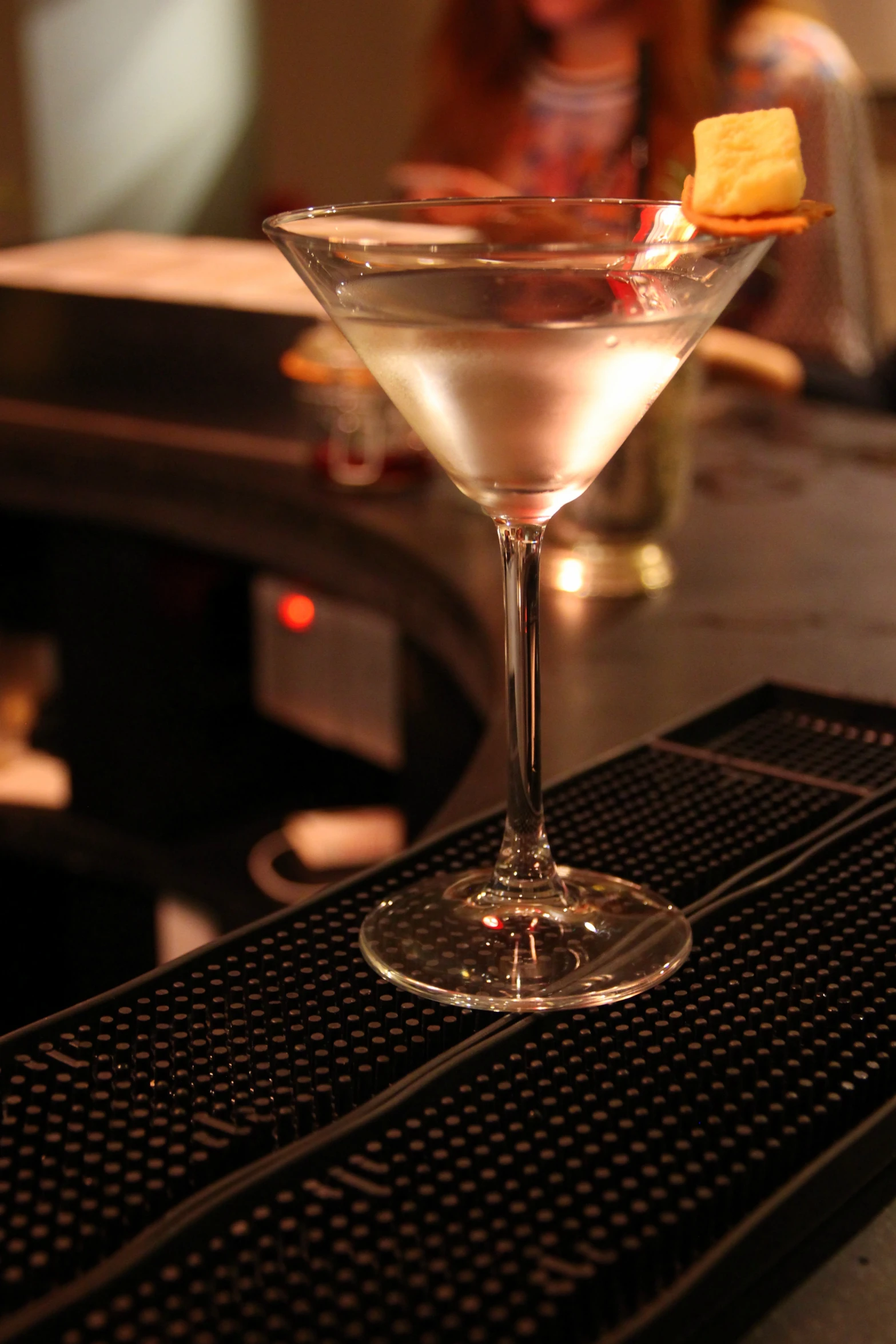 a martini glass with an orange slice and a beverage