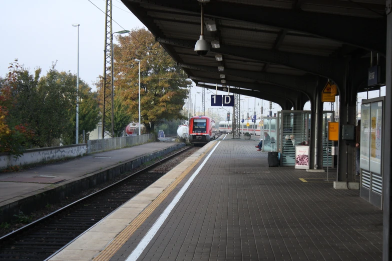 two red trains at the railway platform