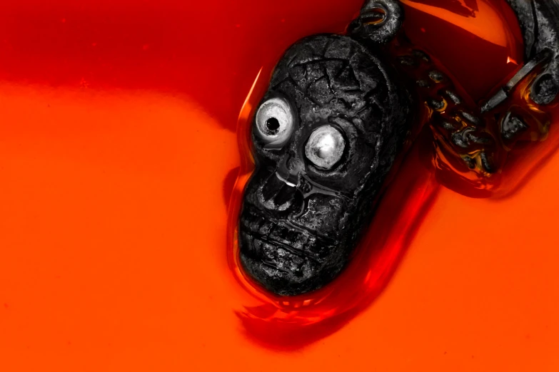 the face of a skull is on an orange surface