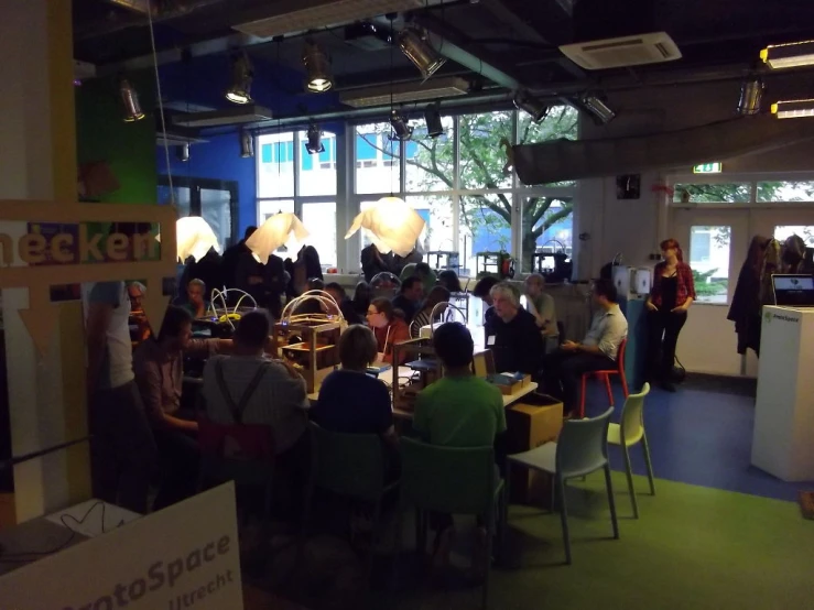 a group of people sitting around tables in a room