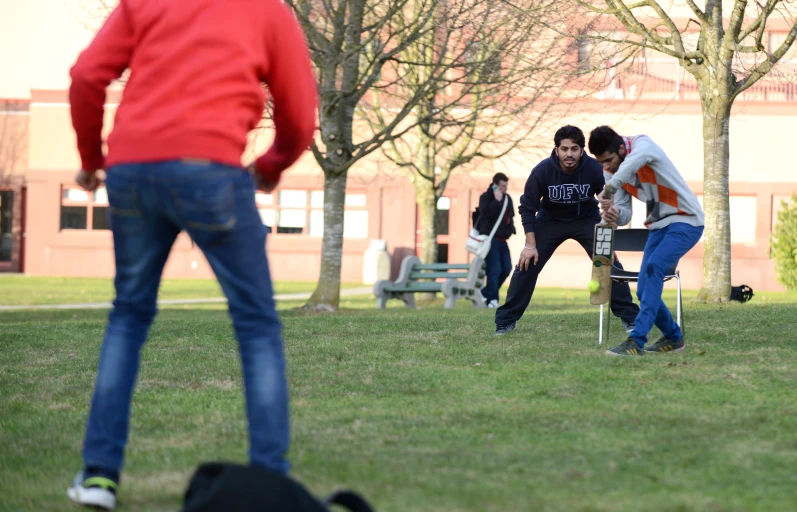 a group of guys playing a game with a frisbee