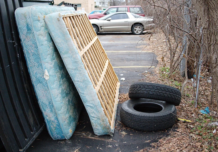 some broken skateboard lying upside down next to a building