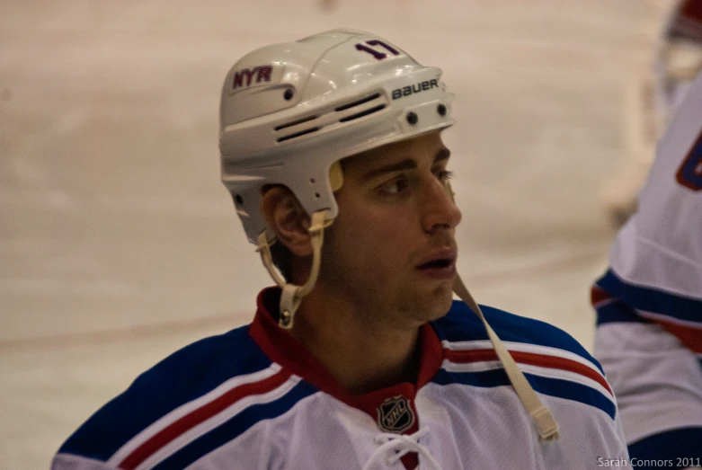 the hockey player is wearing an umpire's uniform