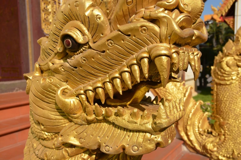 a large golden statue in front of a building