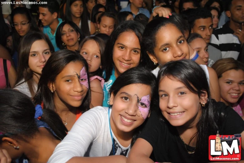 a large group of children all with painted face paint