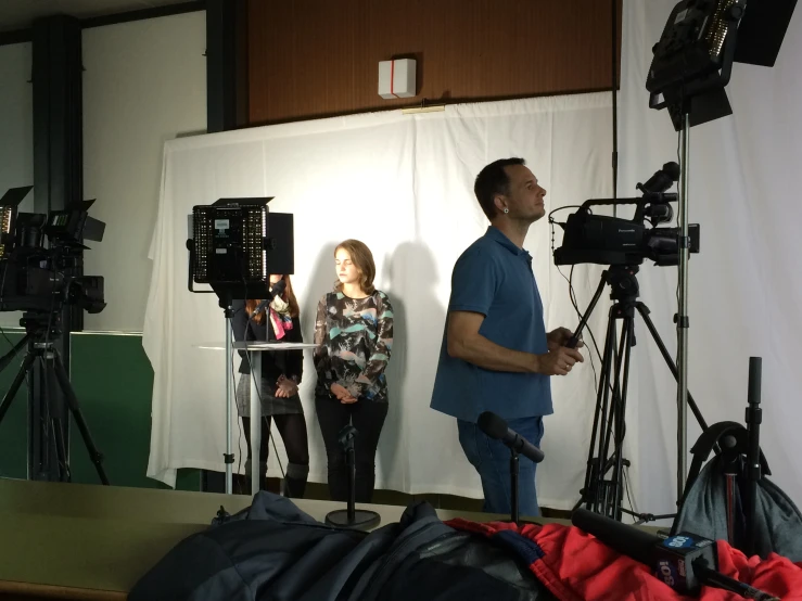 a man and woman are looking up at a camera