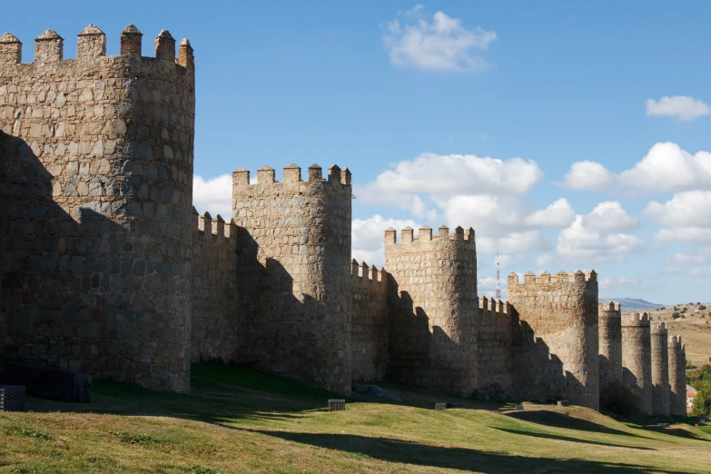 a castle like structure is next to grass