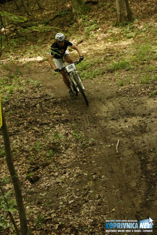 the man is racing his bike on the muddy path