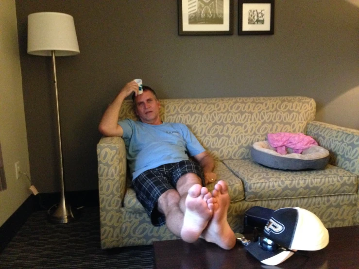 a man laying on top of a couch in a living room