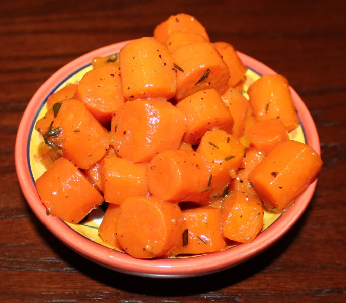 a yellow plate topped with sliced up carrots