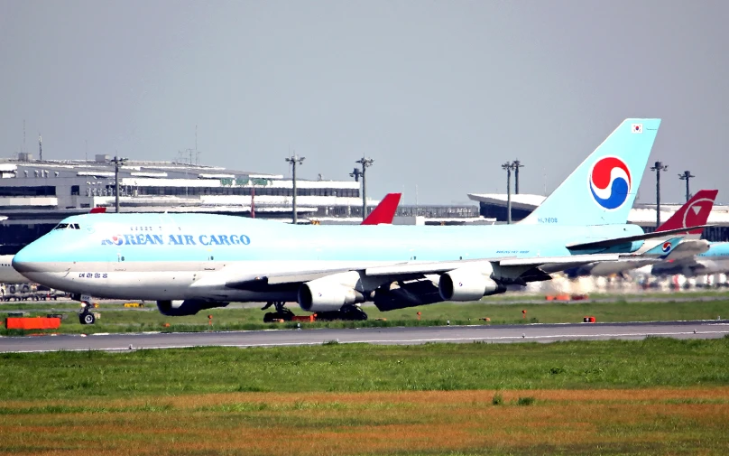 a large blue plane sitting on the runway