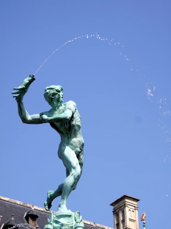 a statue and an older style clock tower behind it