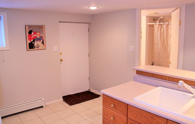 an empty bathroom with tiled floors and a double sink