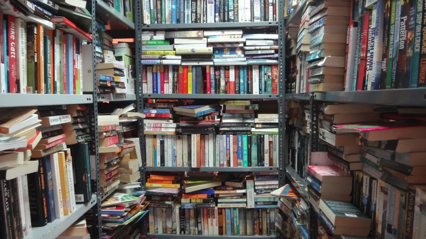 an open book shelf with many books in a liry