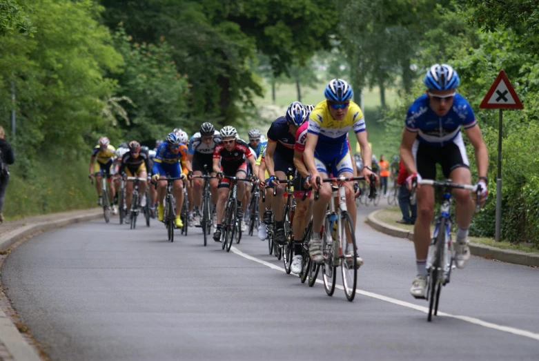 many people riding bikes in a race on a road