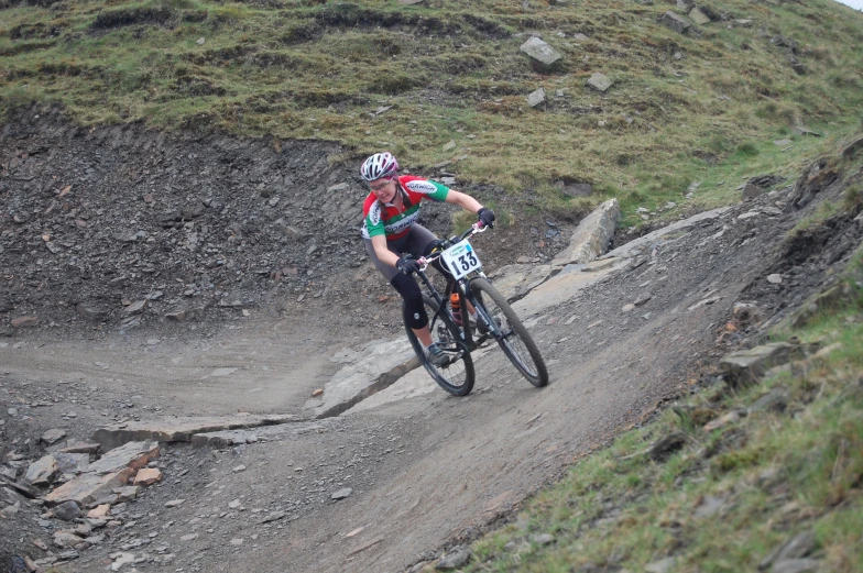 a cyclist is racing down a dirt path