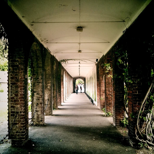 the hallway is full of columns and a brick walkway