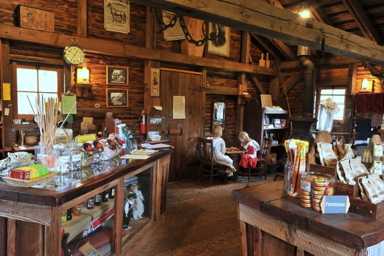 an old wooden cabin with many items on the counter