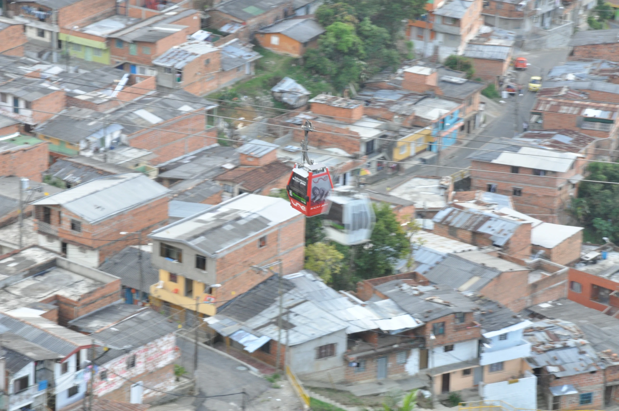 an aerial view of buildings with a wire above them