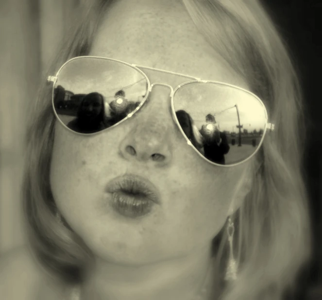 black and white image of a young woman wearing sunglasses