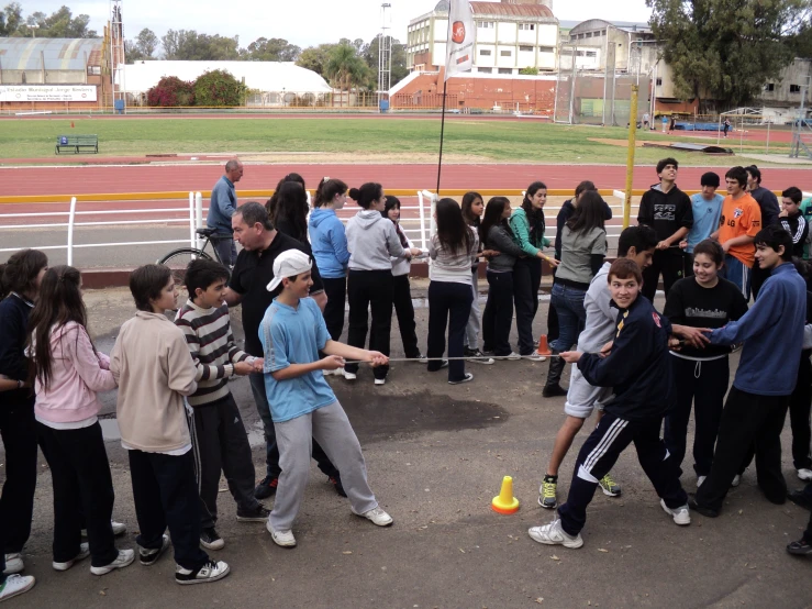 a group of people standing on top of a tennis court