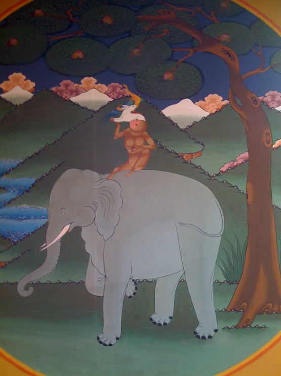 a painted mural depicting an elephant holding onto a tree