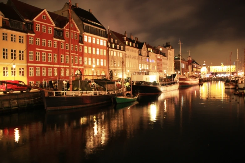 several boats docked next to old buildings near the water