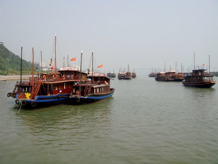 the boats are in the water together outside