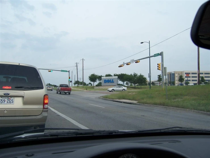 a white van is driving down the street