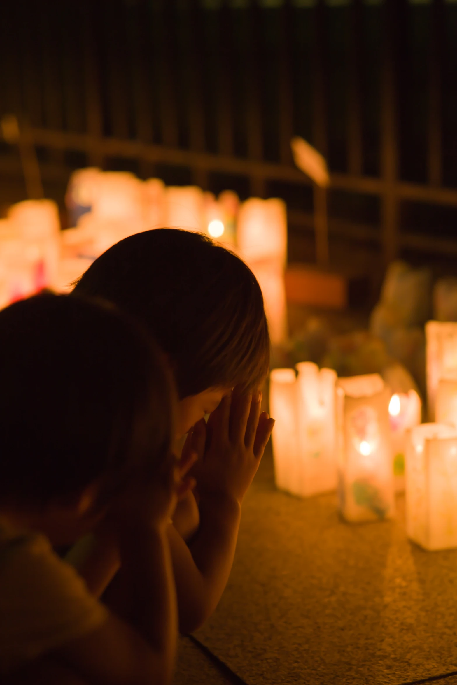 a woman is sitting in front of some candles