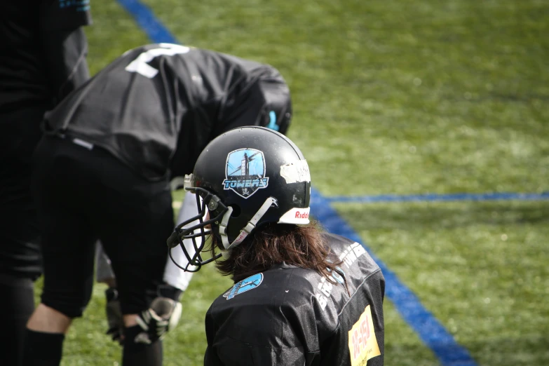 an image of football players talking during practice