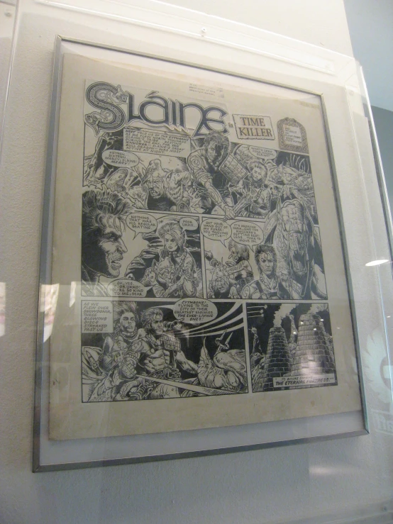 an older comic page is framed in glass