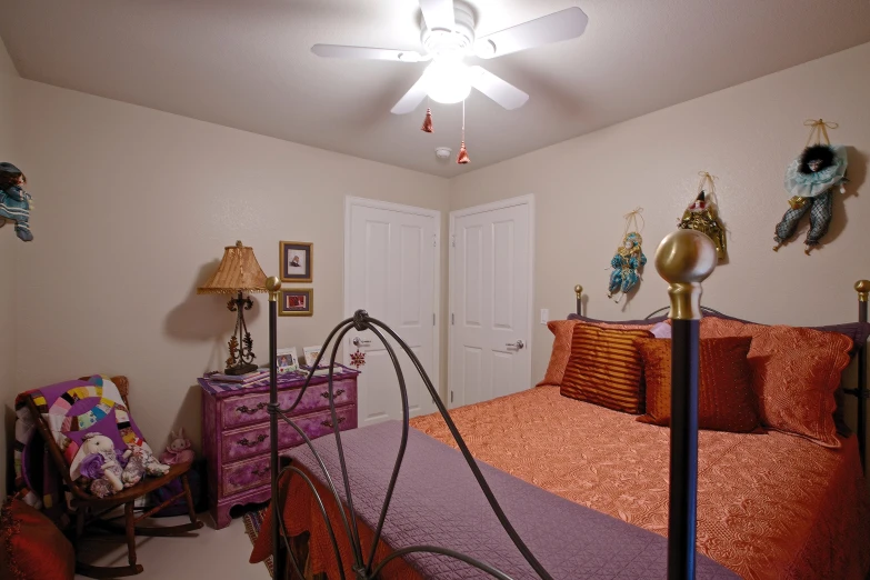 a bedroom with a ceiling fan and many items