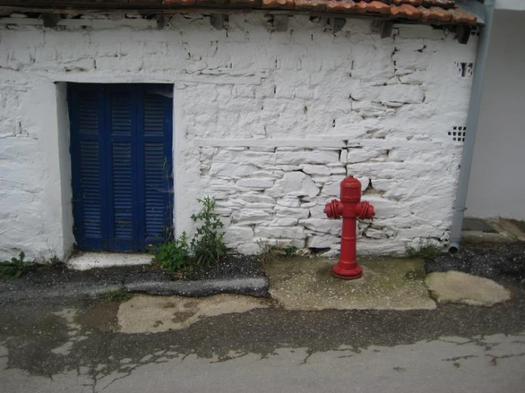 the fire hydrant is standing on a small sidewalk