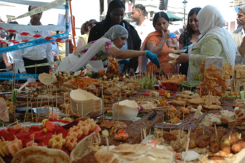 a woman in a white hijab and scarf is serving a dessert