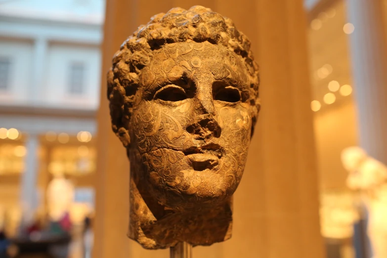 a clay head is on display at the museum