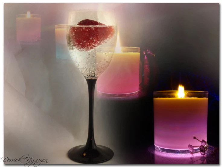 three lit candles with some different colored glass