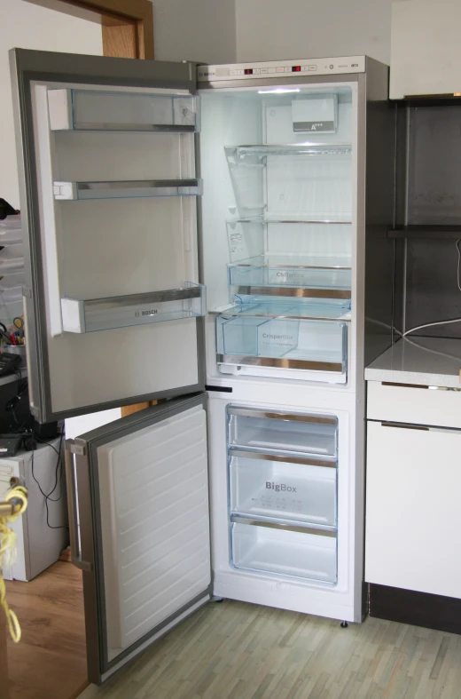 a refrigerator has both the doors open and is white