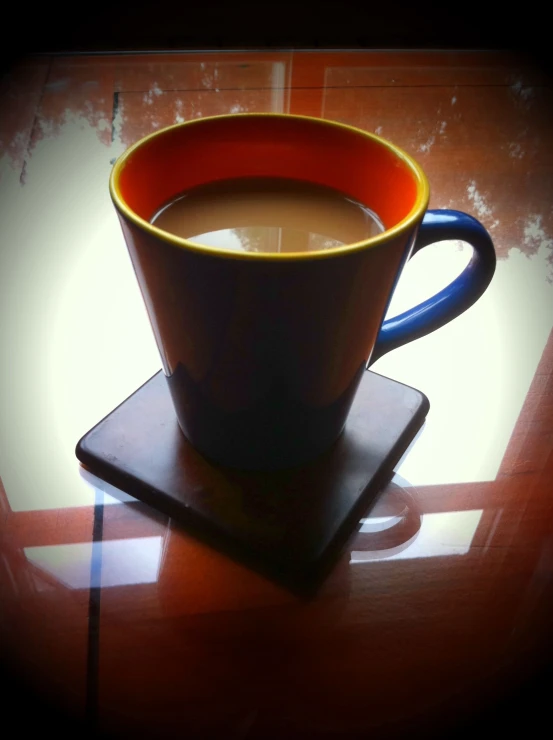 a cup with a saucer on a coaster