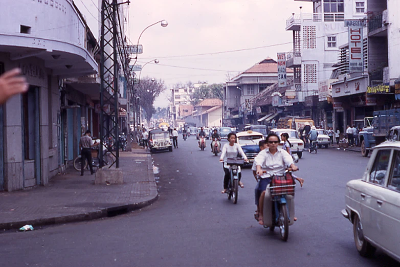 a group of people on bikes driving down the street