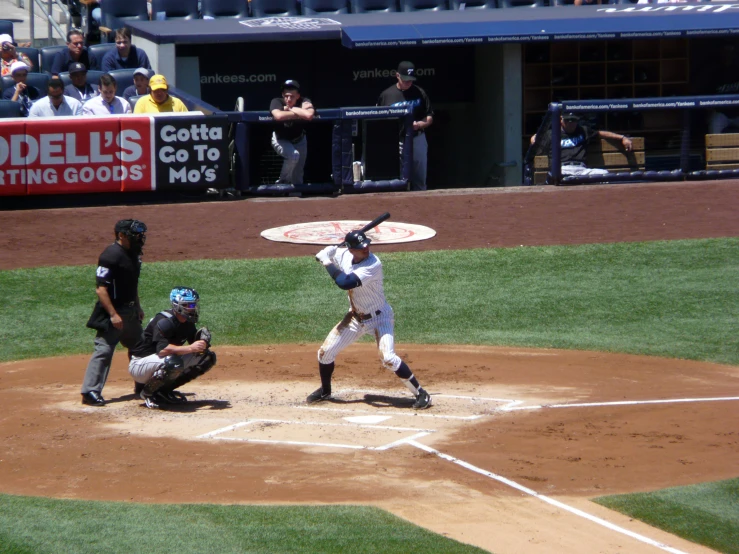 people in a baseball game watching a player hit a baseball