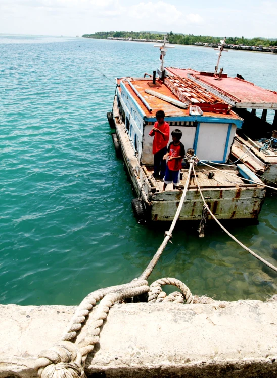 two people on a boat sitting in the water