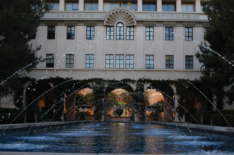 an open space building with an open pool of water in front