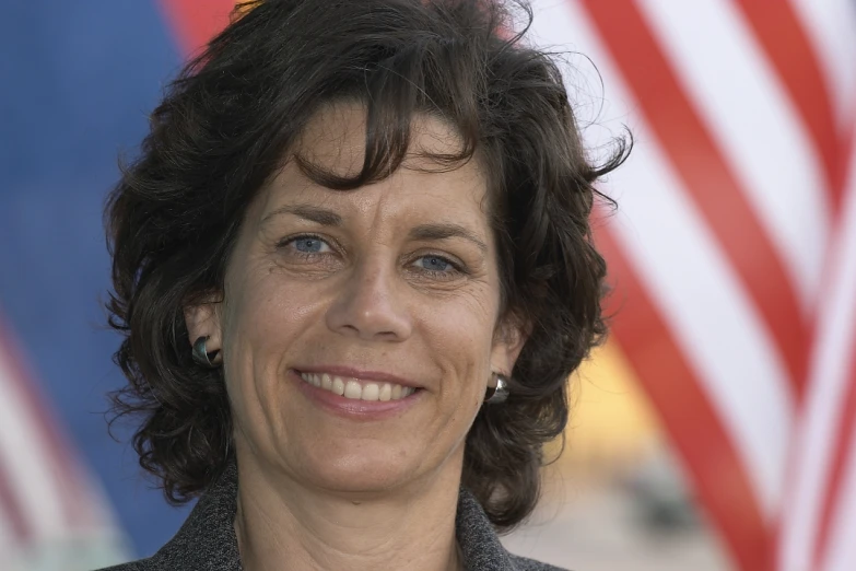 a lady with short hair smiles into the camera