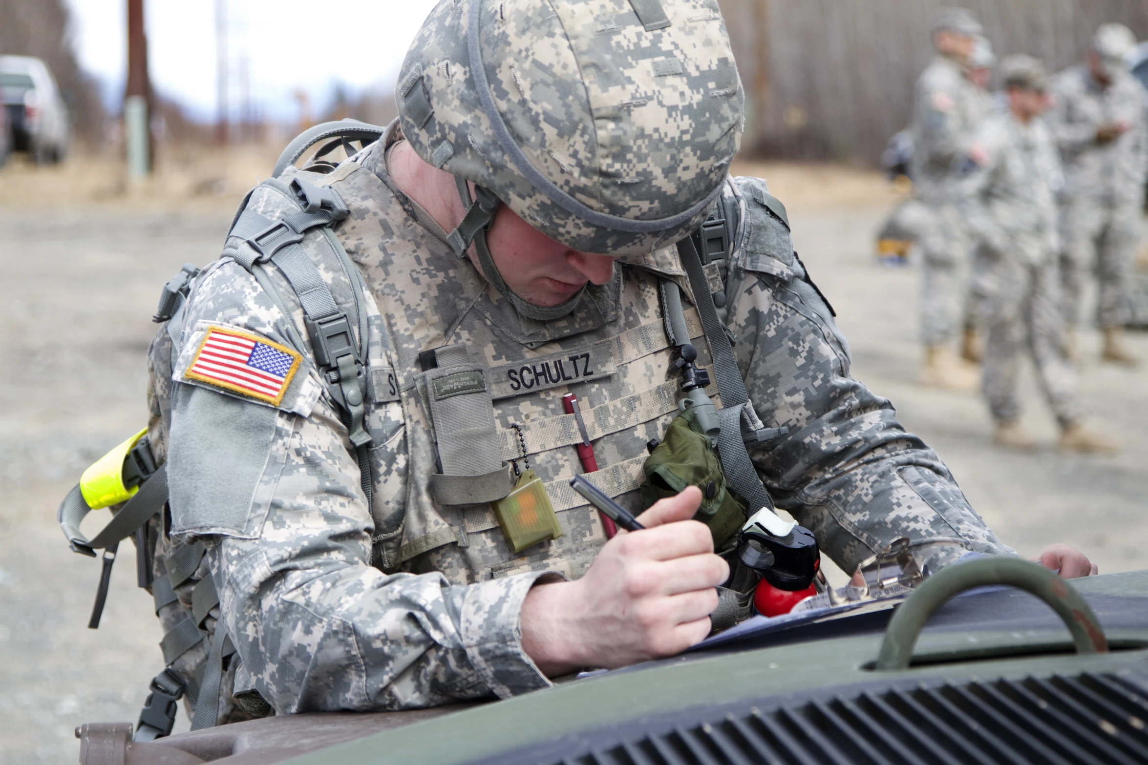 a person in the army putting soing into an object